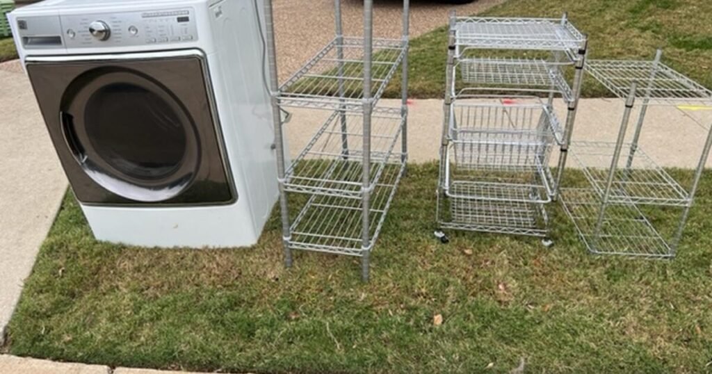 Difficult waste: Discarded washing machine and metal shelving units on grass. Bulky waste disposal.