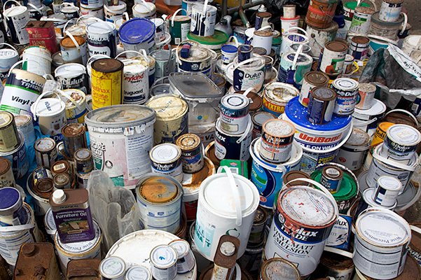 Pile of discarded paint cans. Difficult waste disposal.