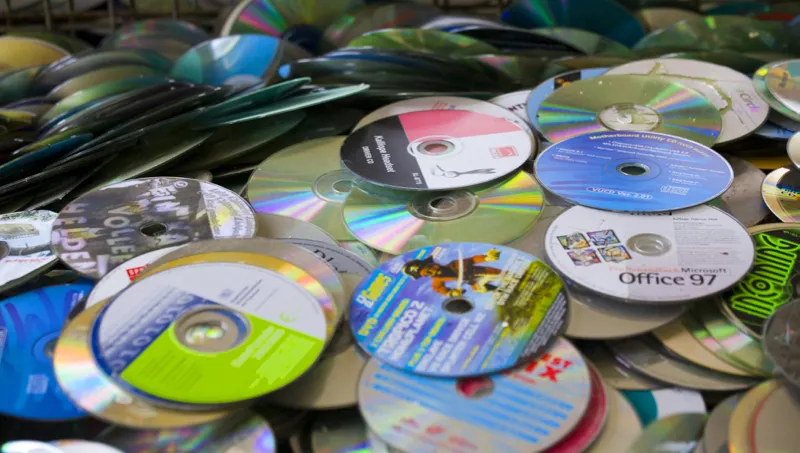 Pile of CDs and DVDs for recycling. Difficult waste disposal concept.