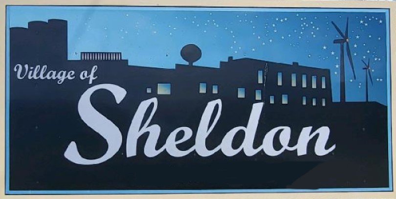 Village of Sheldon service area. Skyline includes wind turbines and stars.