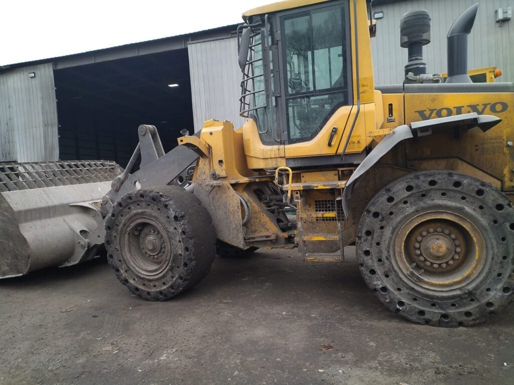 Yellow Volvo wheel loader. Heavy equipment for material transfer.