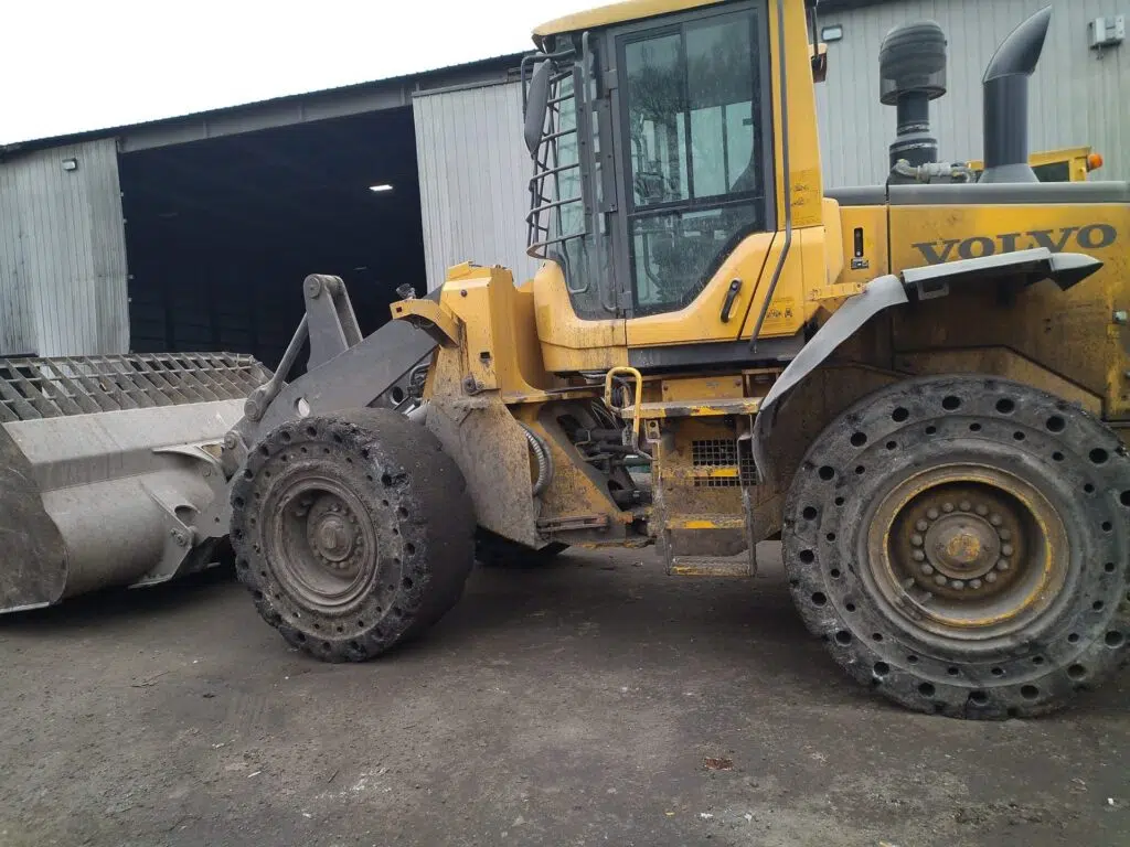 Yellow Volvo wheel loader. Heavy equipment for material transfer.
