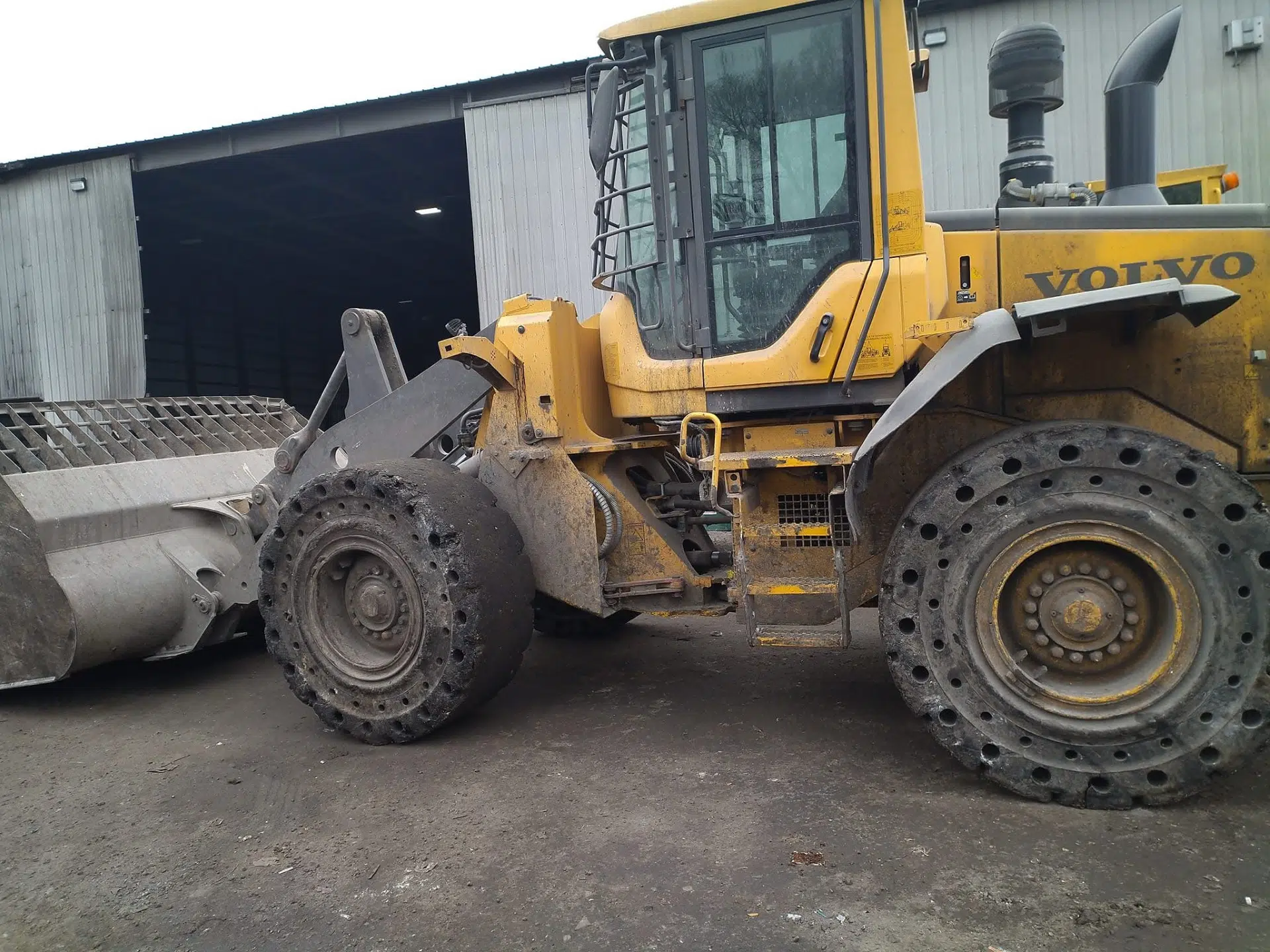 Yellow Volvo wheel loader. Heavy equipment for material transfer.